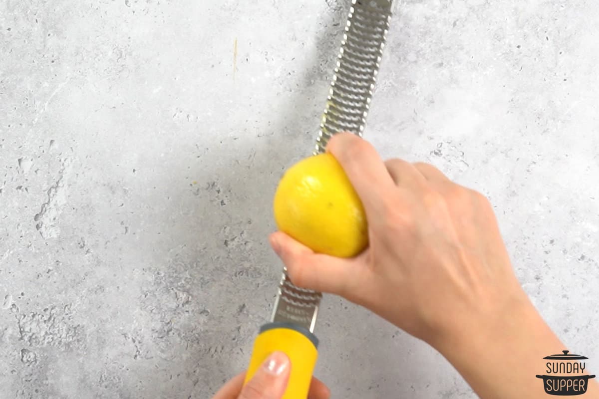 lemon being zested on a zester