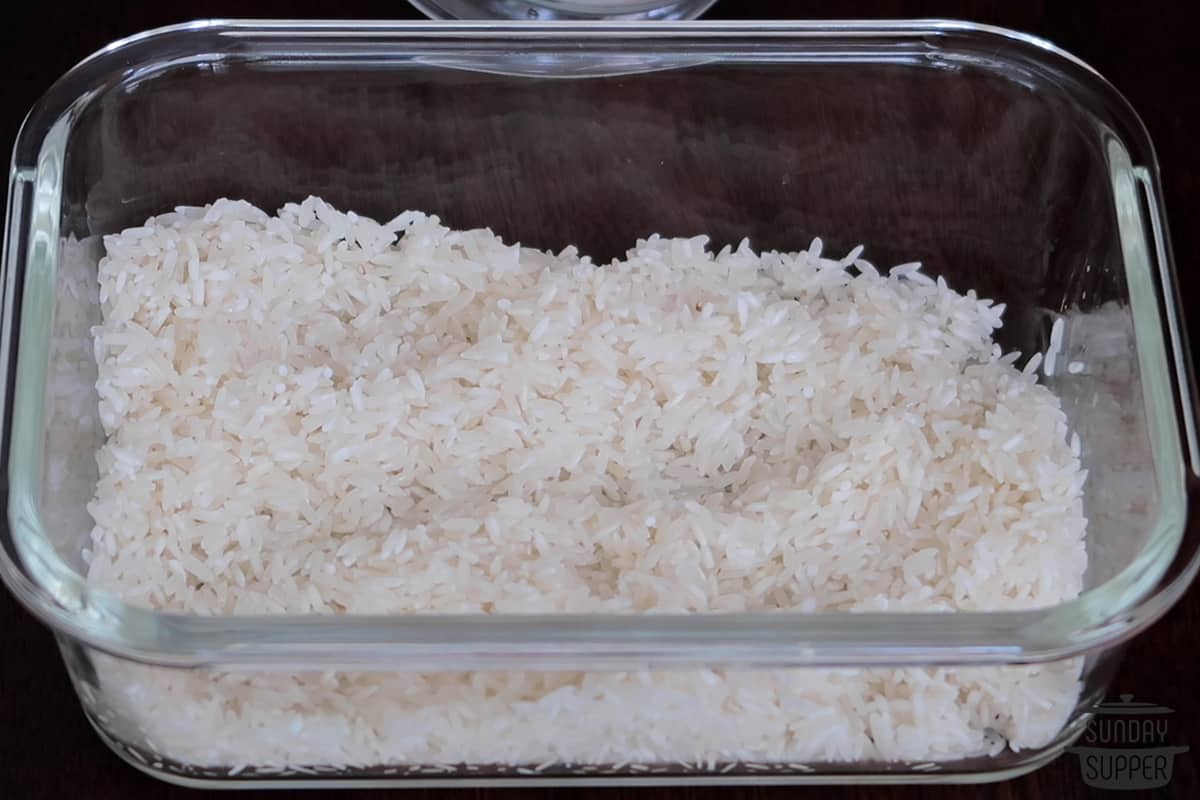 adding washed rice to a container