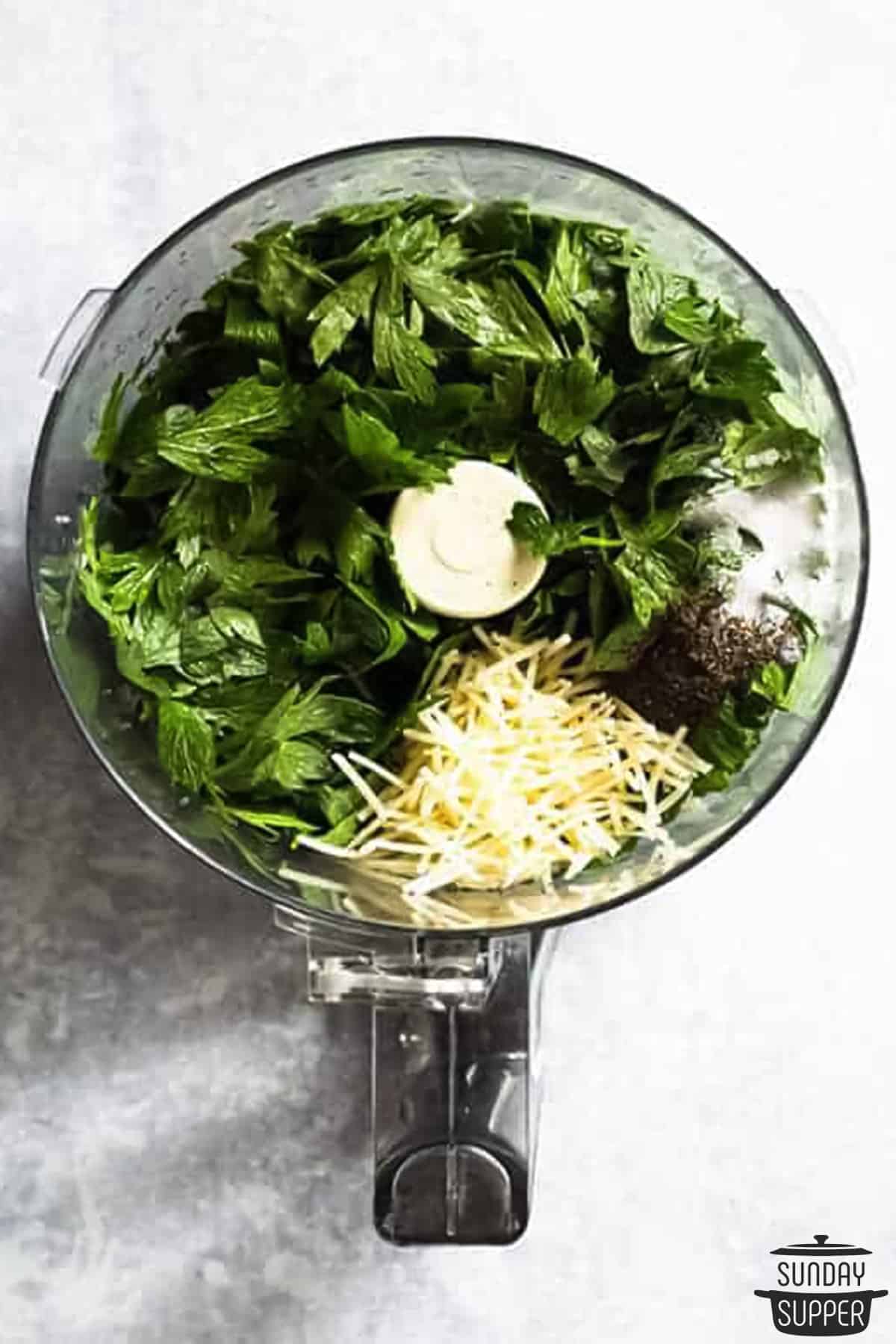 all the pesto ingredients added to a blender