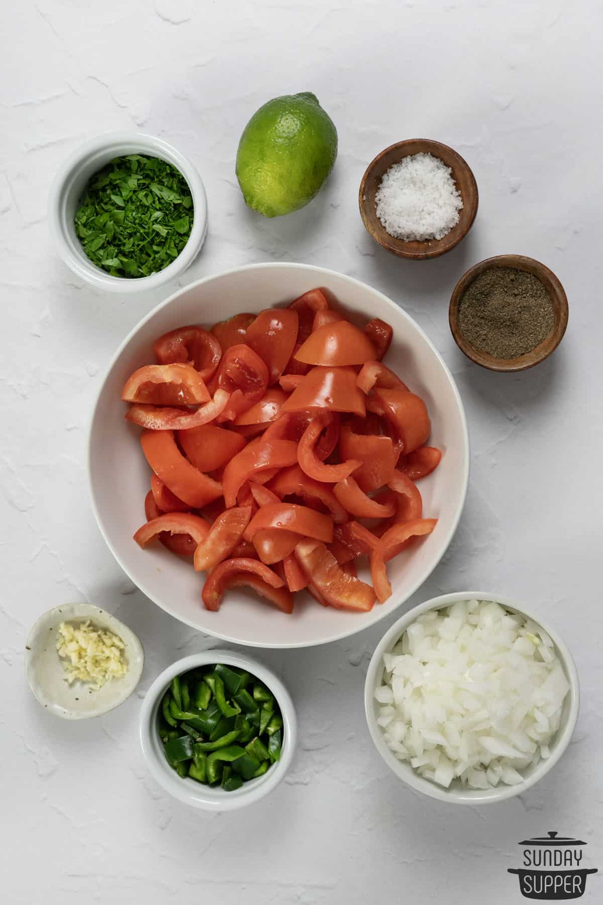 ingredients to make tomato salsa in bowls