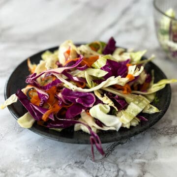 a dinner plate filled with asian coleslaw