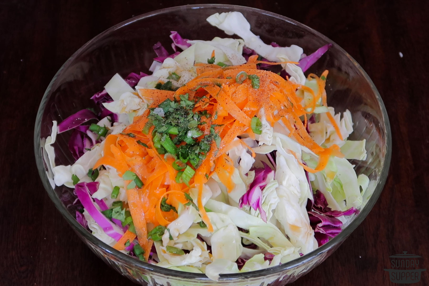 all the ingredients for asian coleslaw added to a bowl