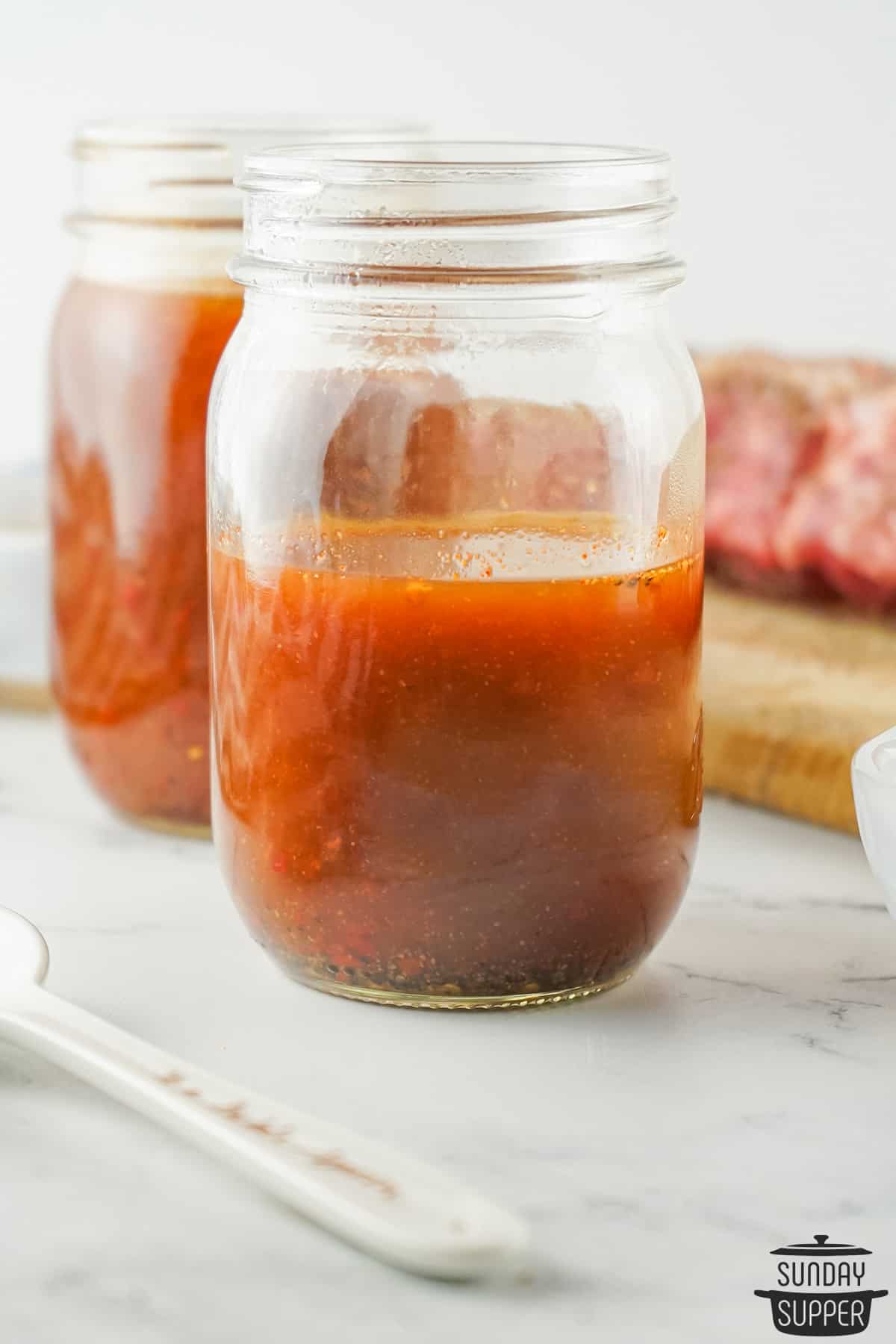 a glass mason jar filled with carolina BBQ sauce
