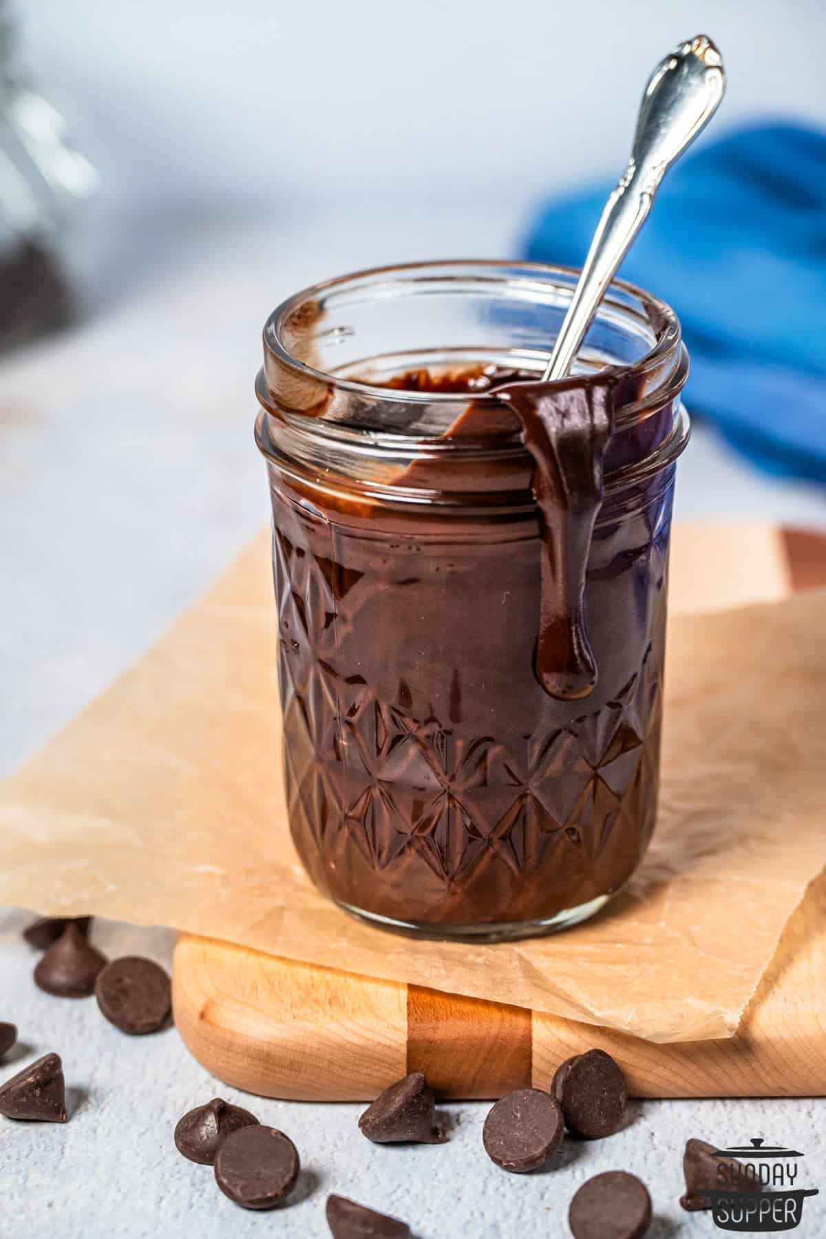 a mason jar of chocolate sauce with a spoon