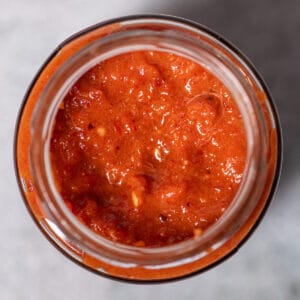 a top down view of harissa paste in a jar