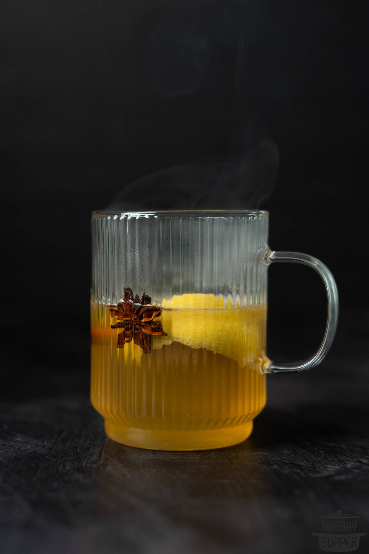 a hot toddy on a counter with steam rising off the top