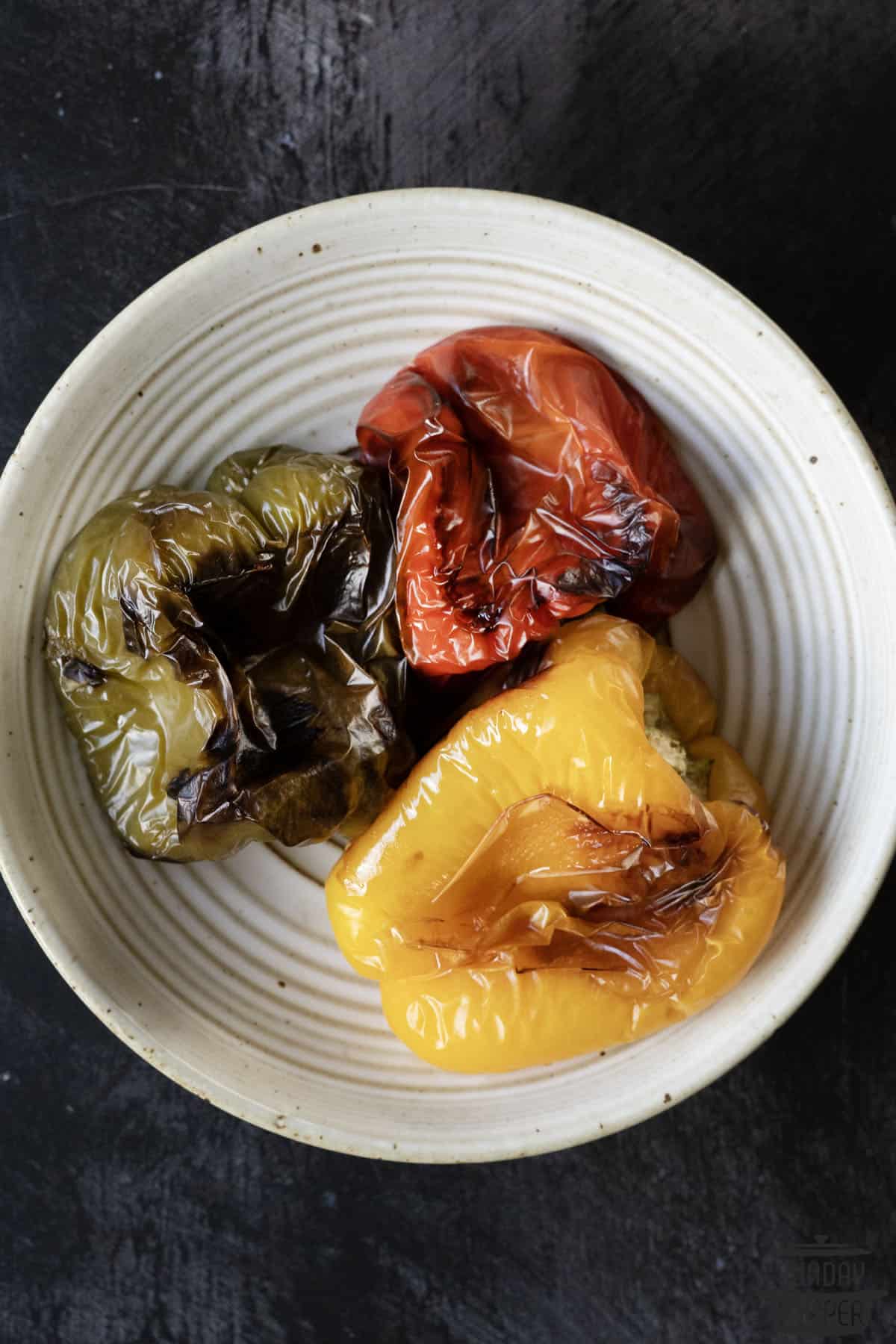 three peppers roasted on a plate