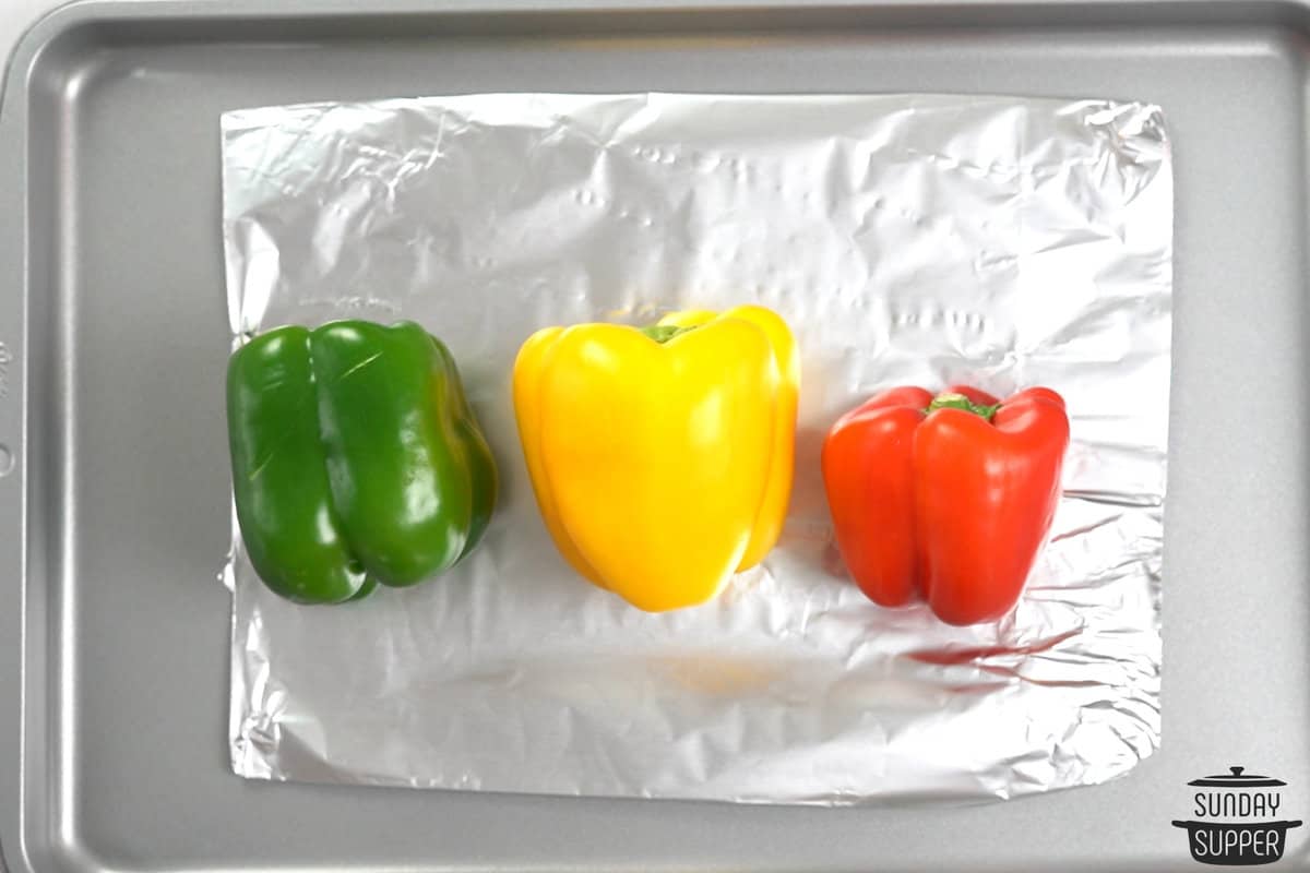raw peppers on a pan with foil
