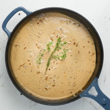 peppercorn sauce in a pan with thyme