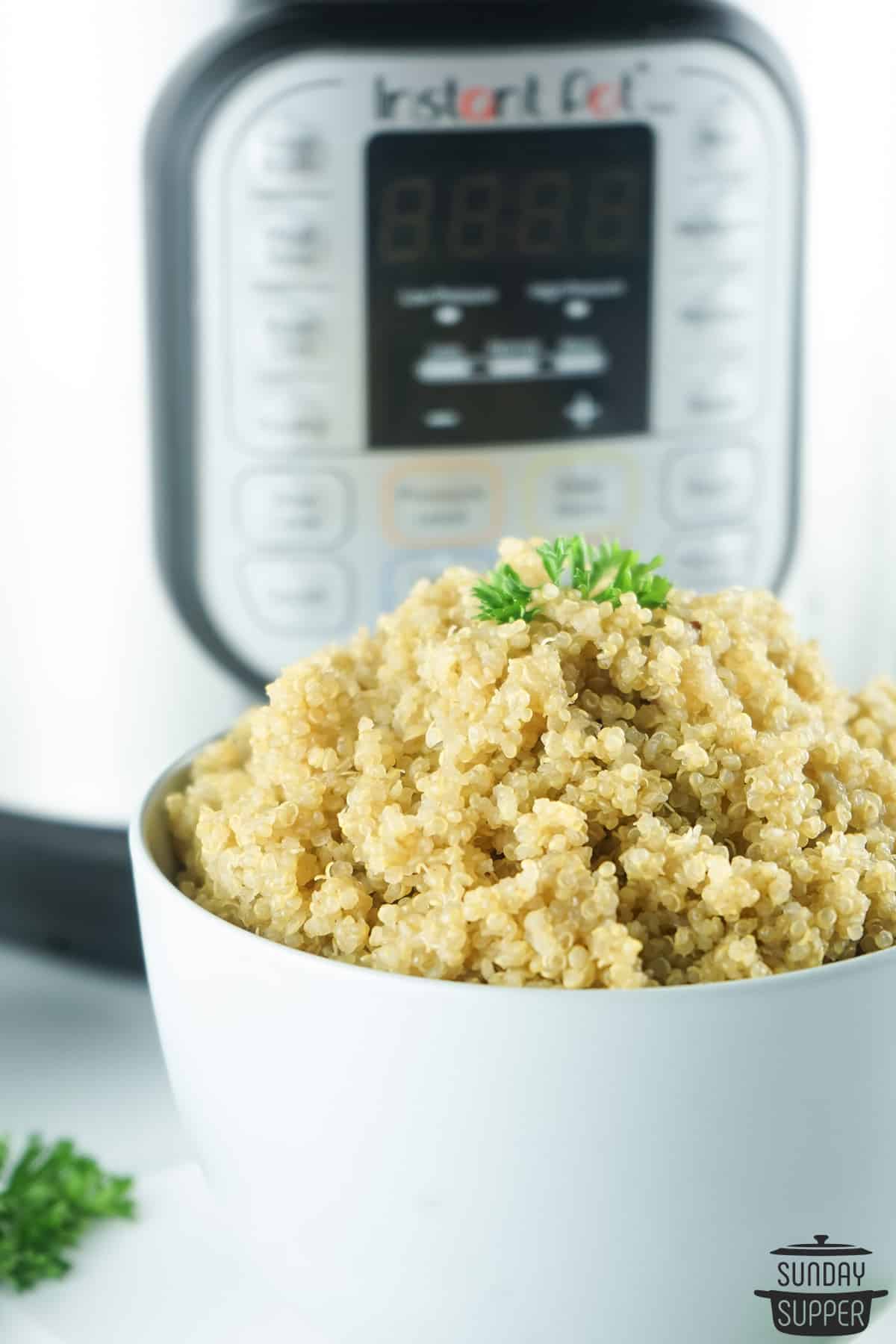 a bowl of instant pot quinoa in front of an instant pot