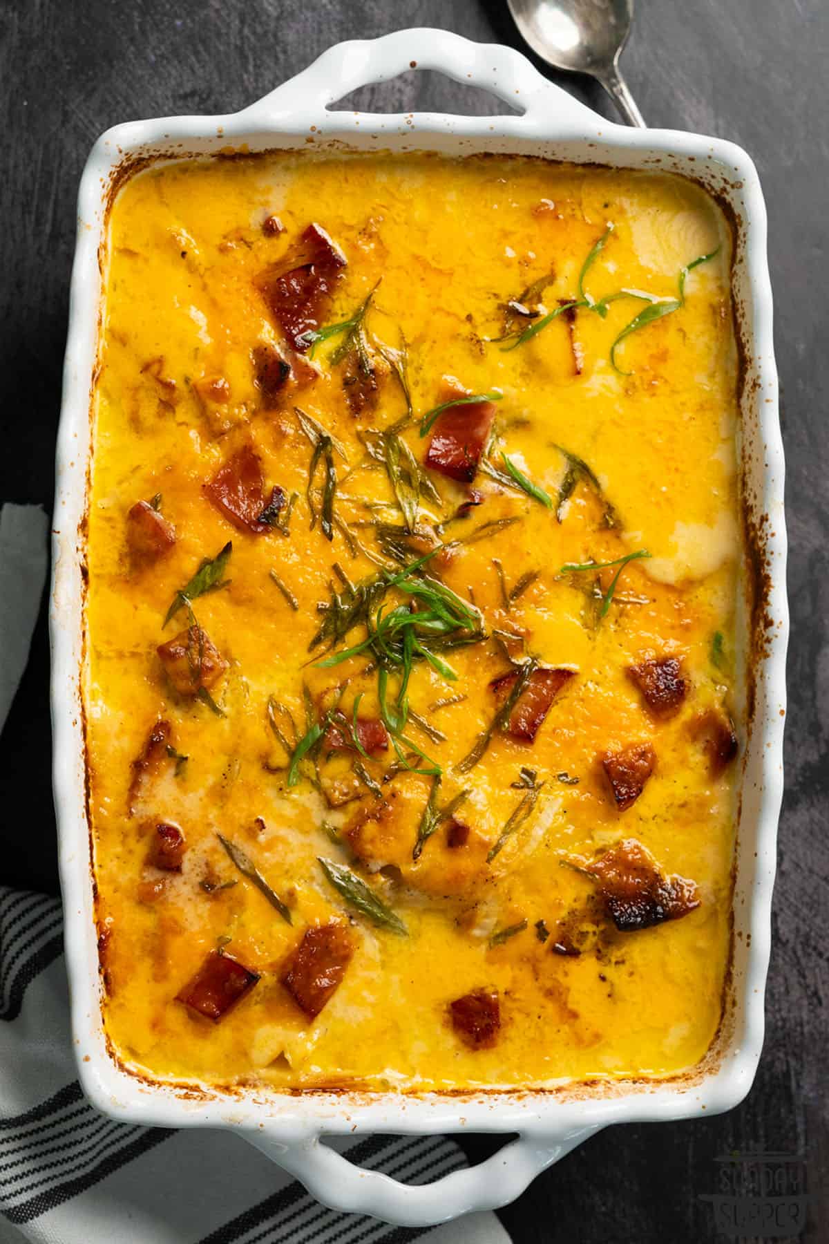a casserole dish of baked scalloped potatoes with ham