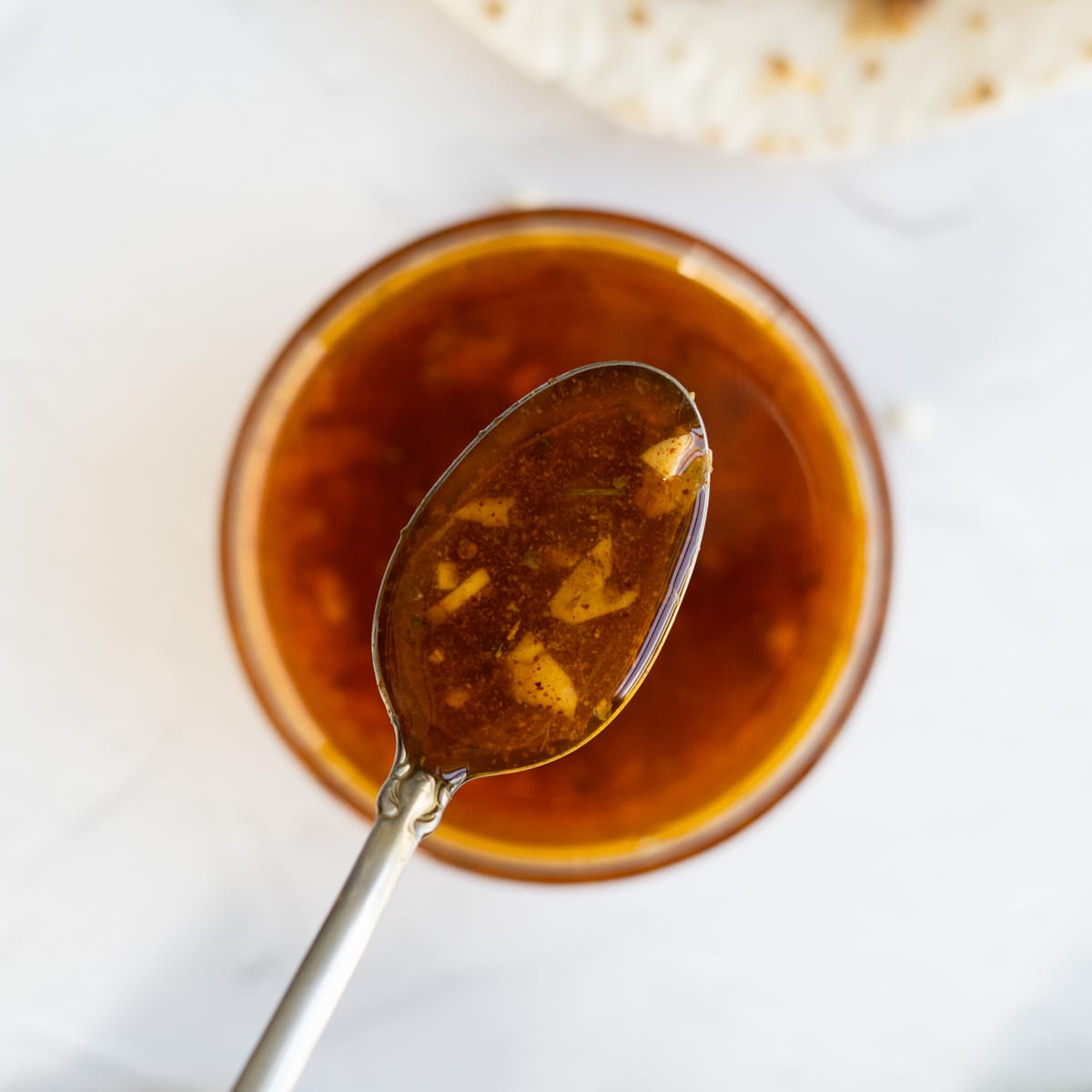 a closeup of a spoon filled with steak fajita marinade