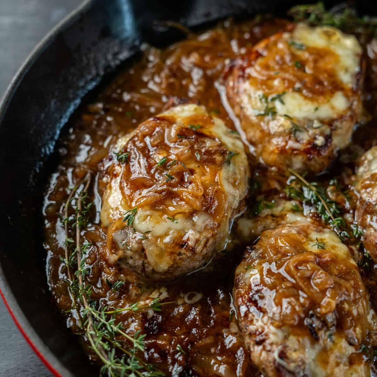 close up of French onion pork chops in a skillet