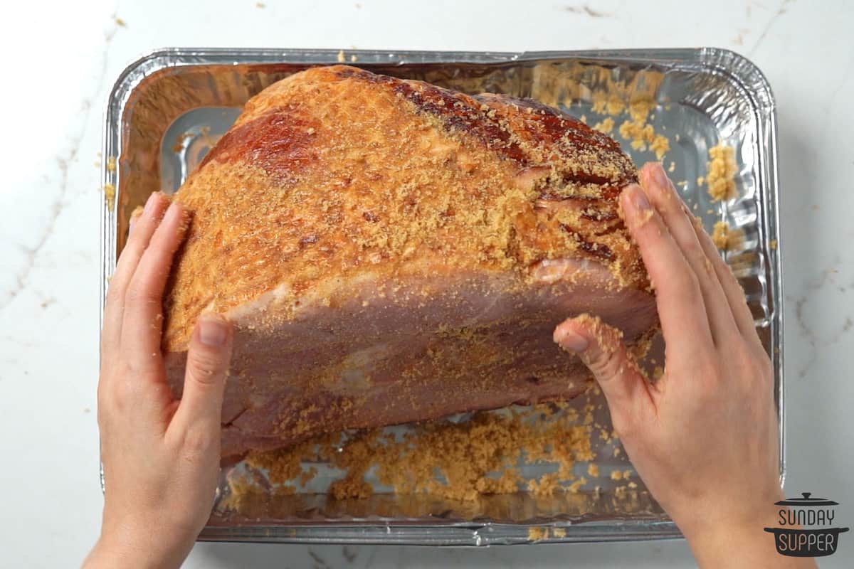 rubbing seasoning on ham