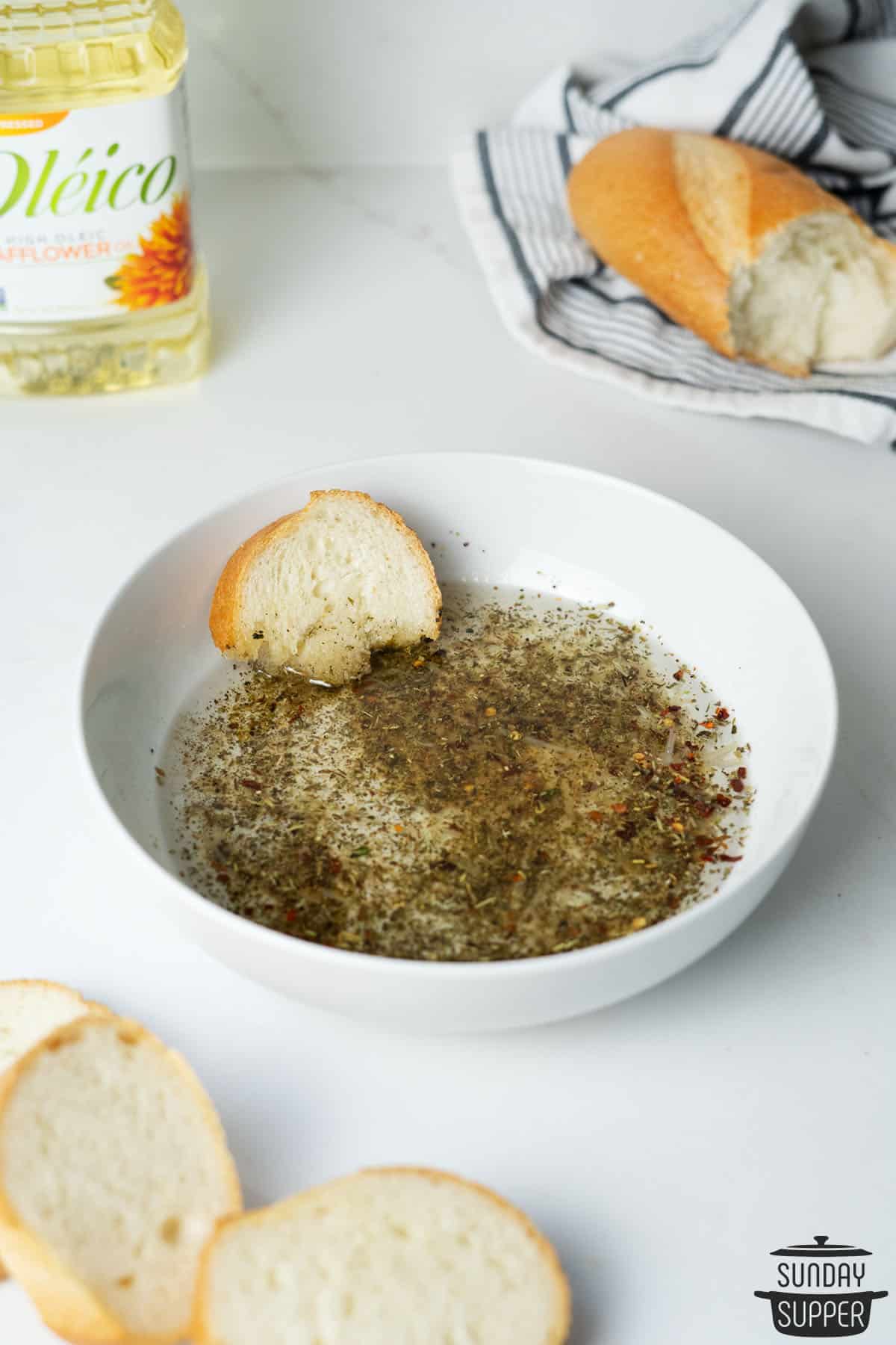 pizza oil dipping sauce in a shallow bowl with bread