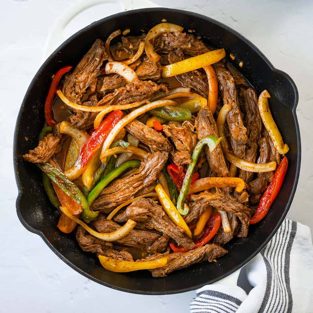 close up of steak fajitas in a skillet