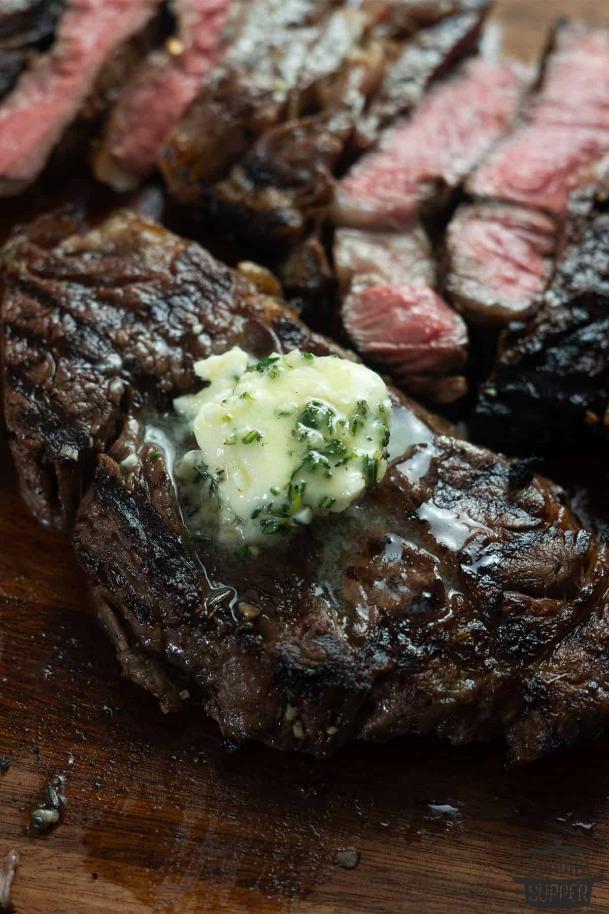 compound butter melting on fresh steak