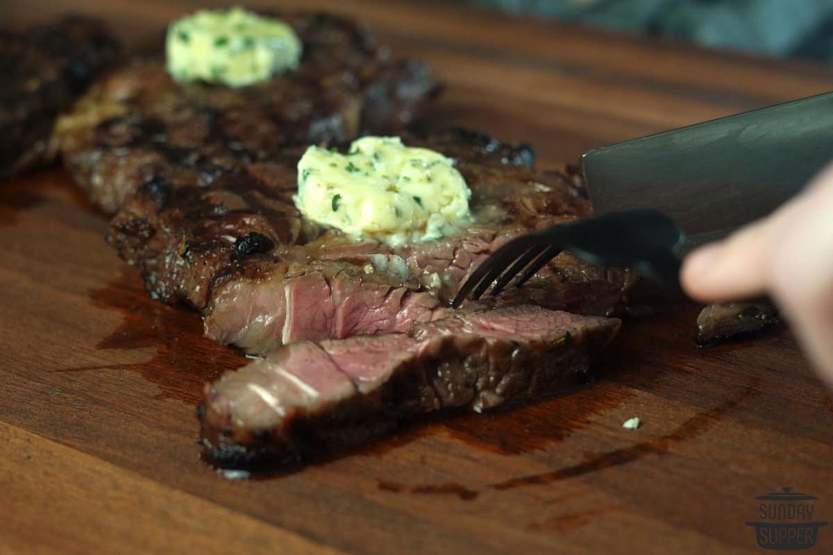 compound butter added to steak that's being sliced