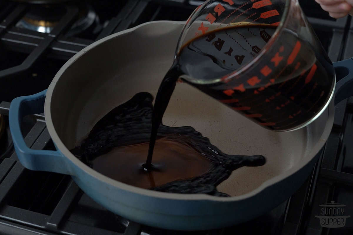 the balsamic vinegar being poured into a pan