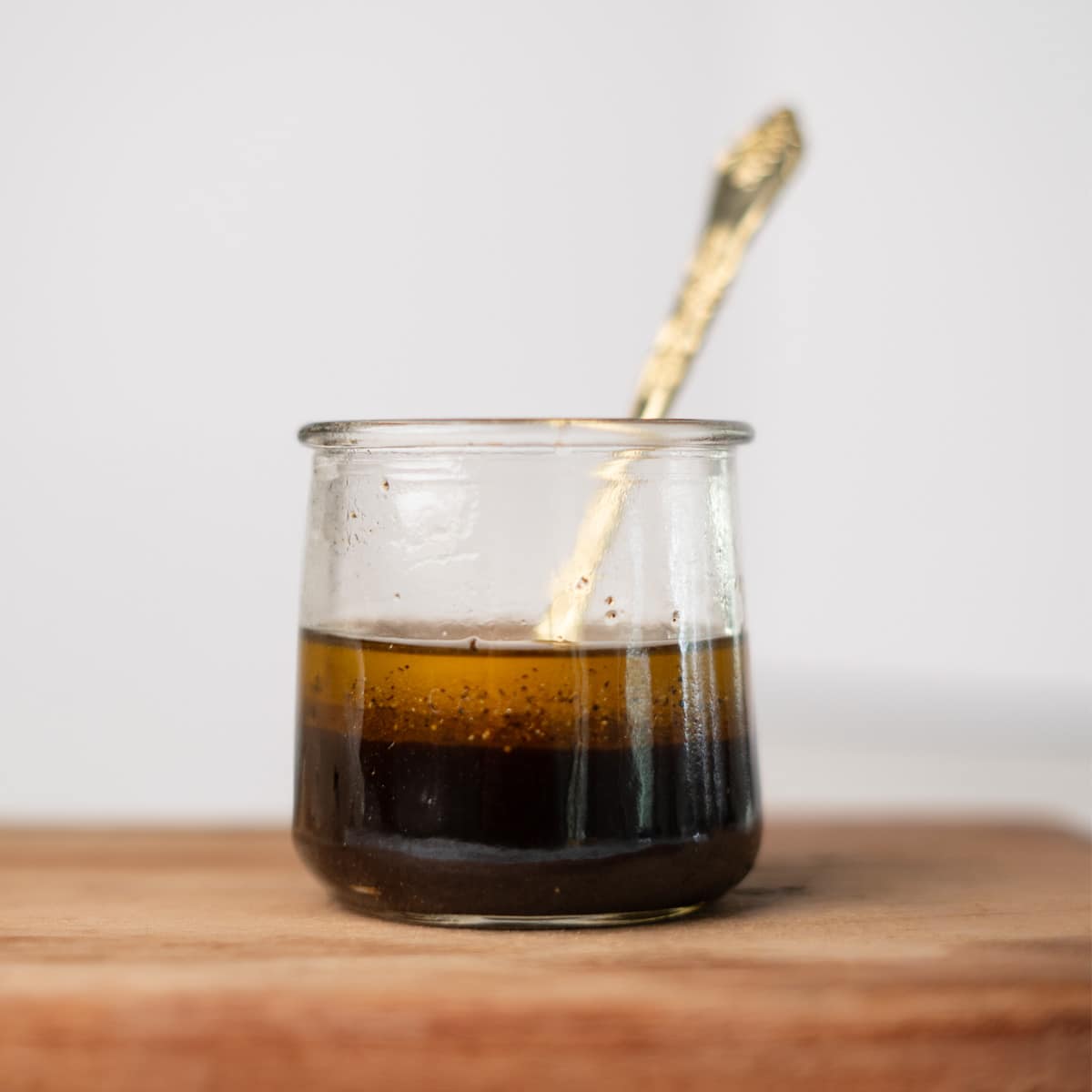 balsamic vinaigrette in a jar with a spoon