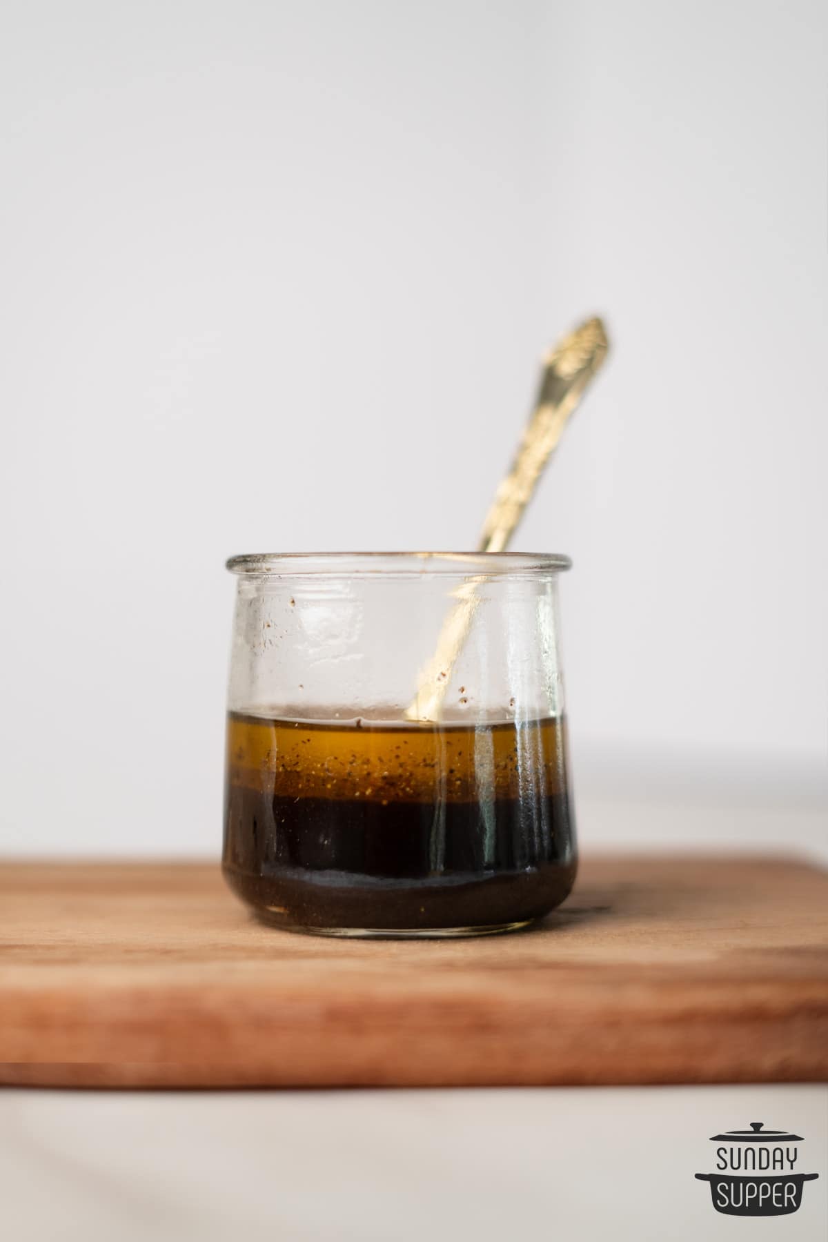 balsamic vinaigrette in an open jar with a spoon
