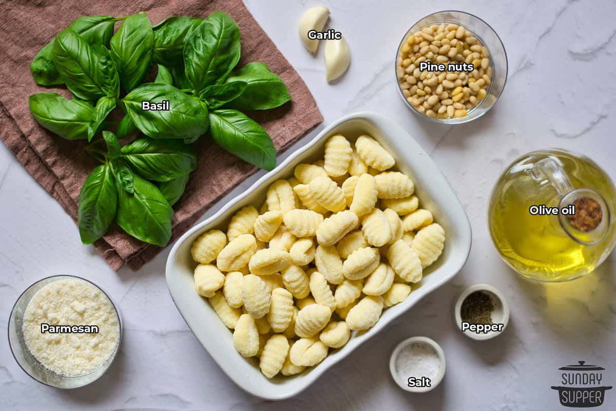 all the ingredients for basil pesto with labels