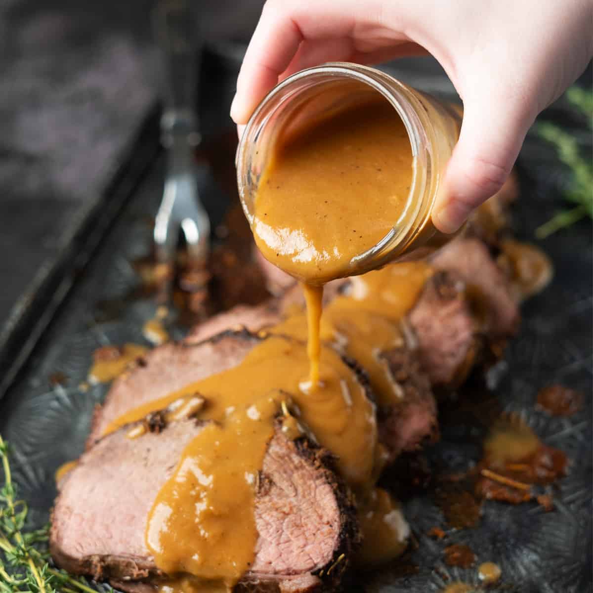 gravy being poured from a jar