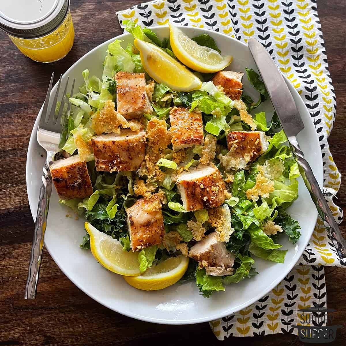 a chicken caesar salad with marinated chicken