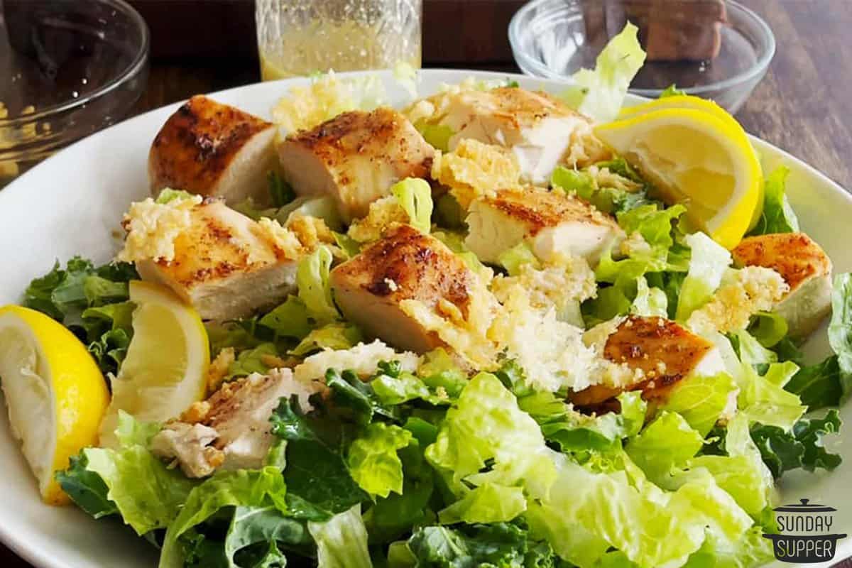 a bowl of salad with marinated chicken