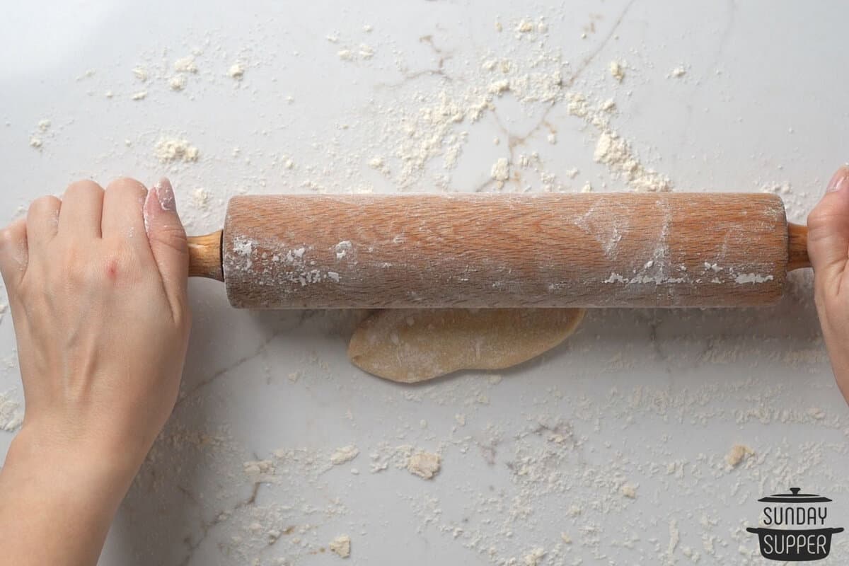 rolling out the ravioli dough with a rolling pin