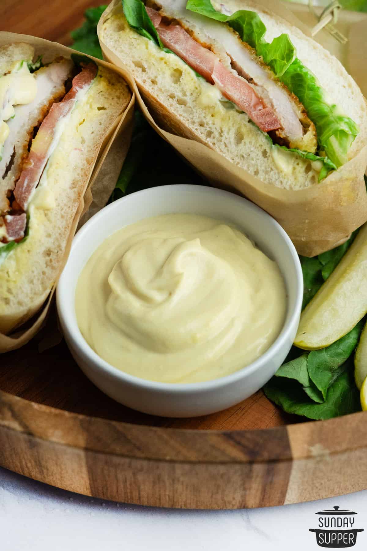 mayo mustard sauce with a sandwich in the background