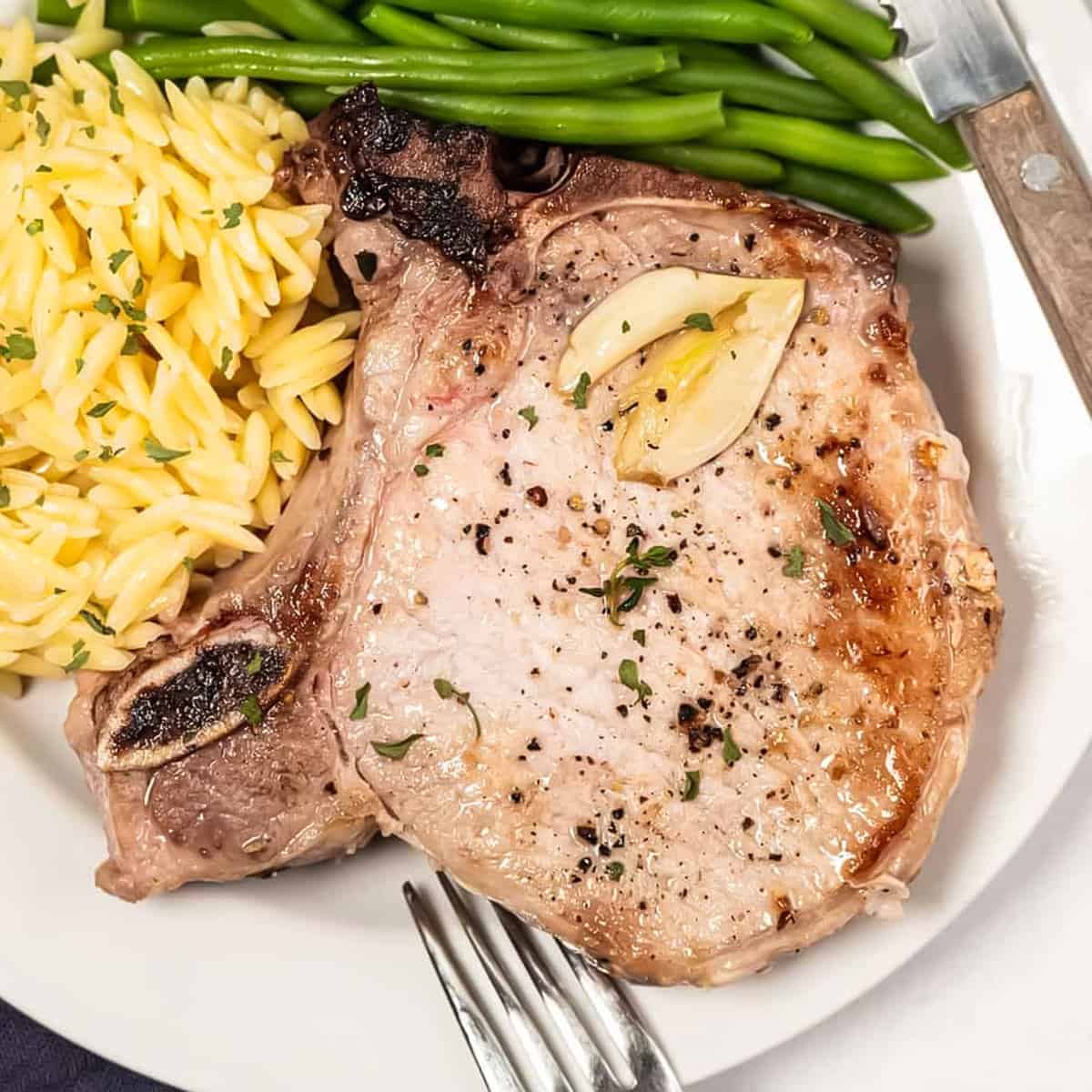 a cooked marinated pork chop on a plate