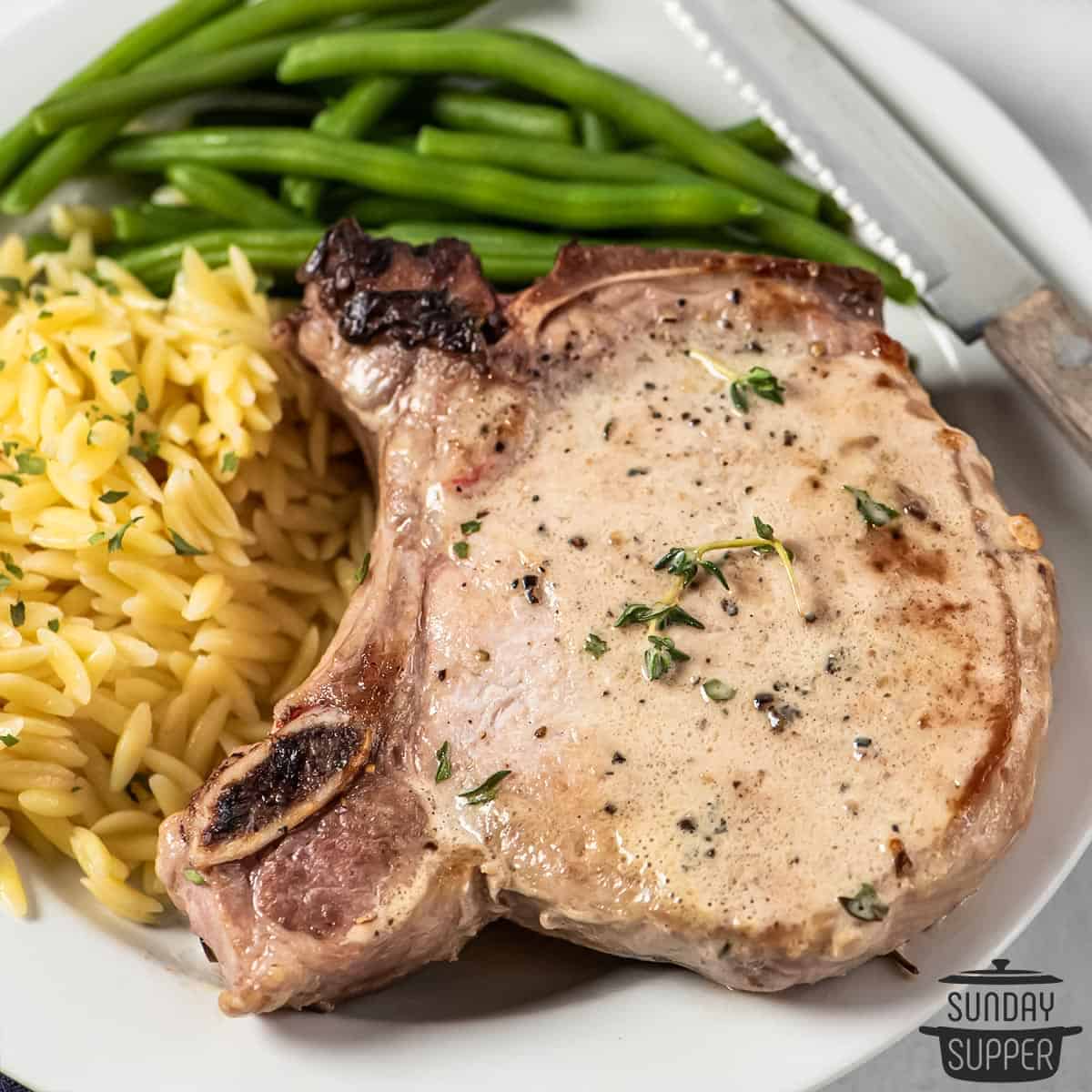 a cooked pork chop on a plate