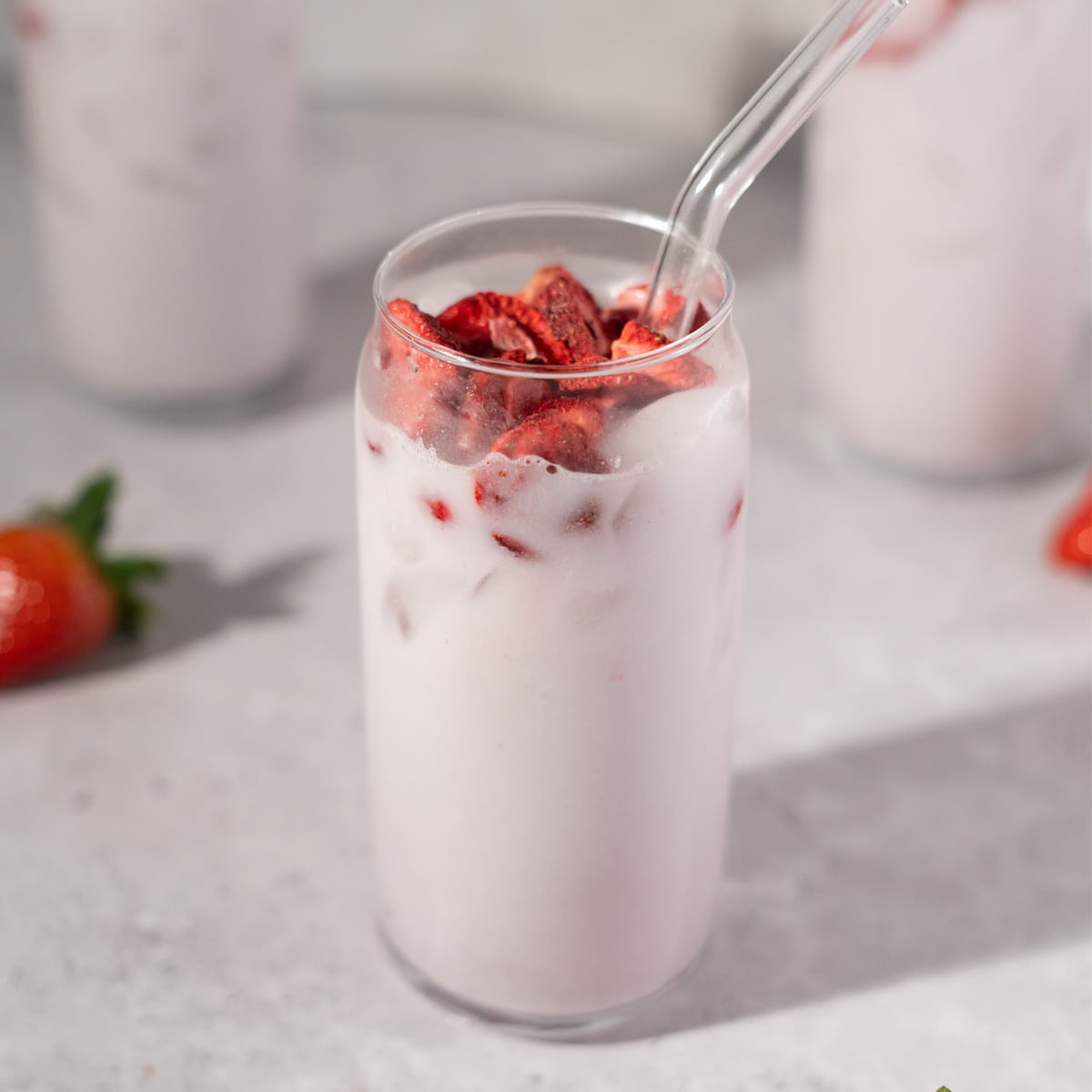 close up of Starbucks pink drink in a clear glass with a straw