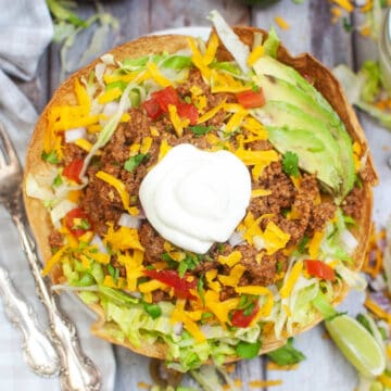 top down view of a taco salad in a toasty tortilla bowl