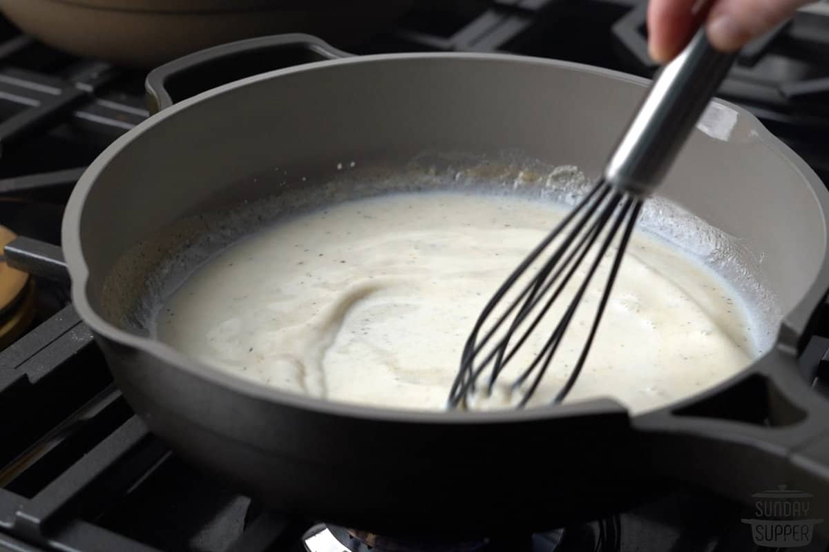 adding milk to flour and butter mixture