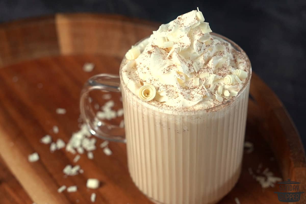 white chocolate mocha in a clear mug with whipped cream on top