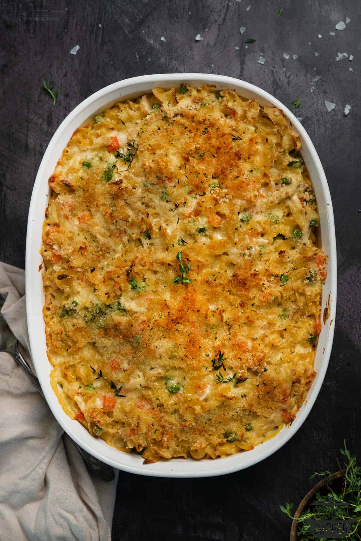 a casserole dish of baked chicken noodle casserole with garnish