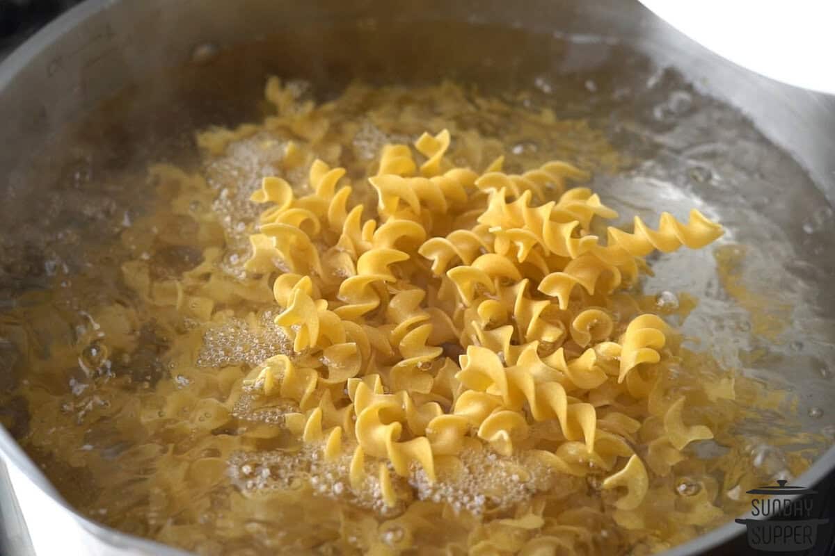 the egg noodles cooking in boiling water