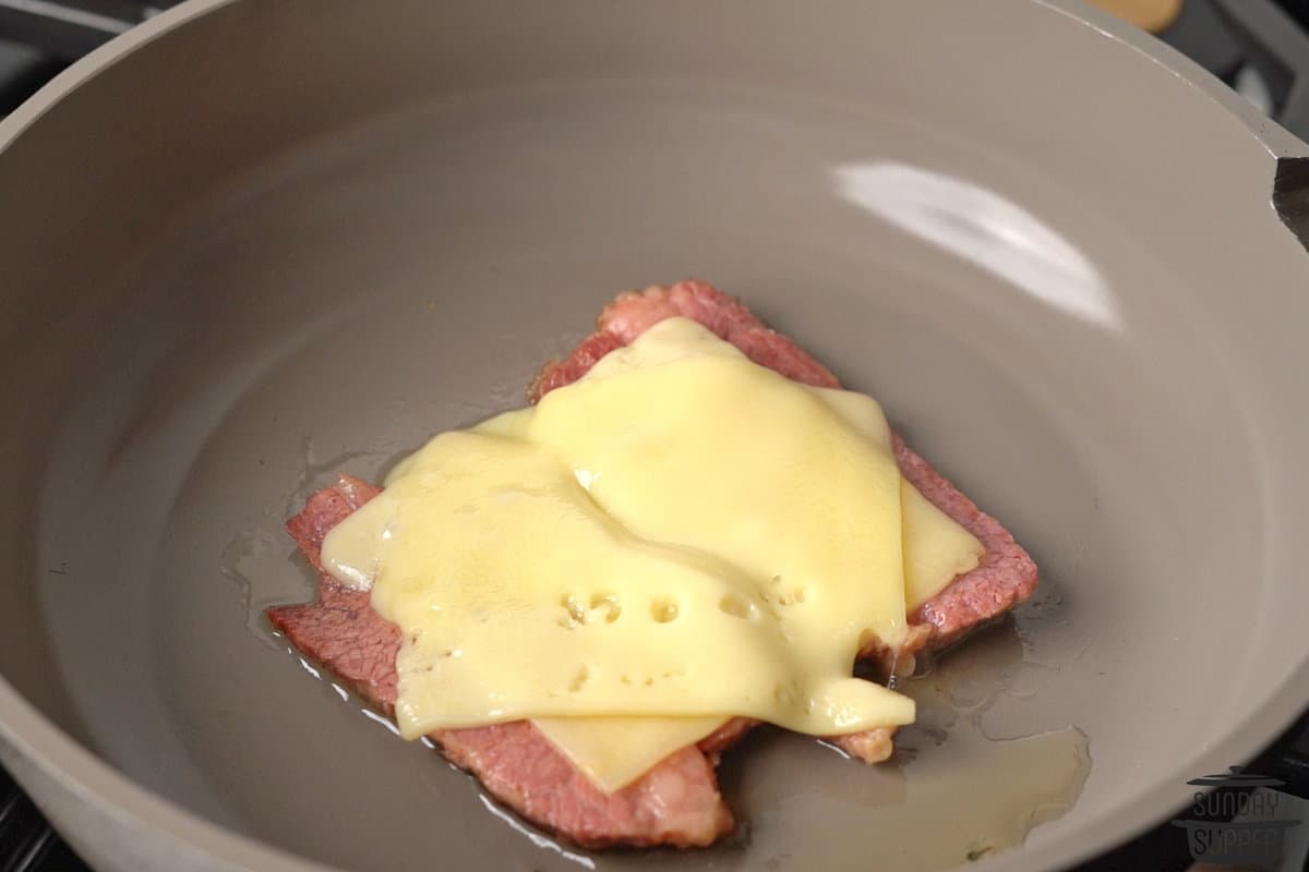 the cheese added on top of the corned beef in the pan