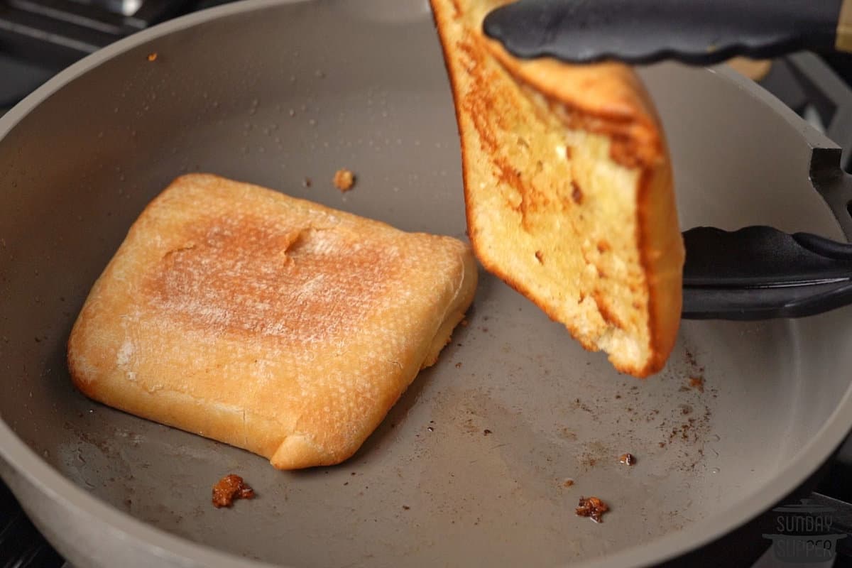 toasting the bun in a pan