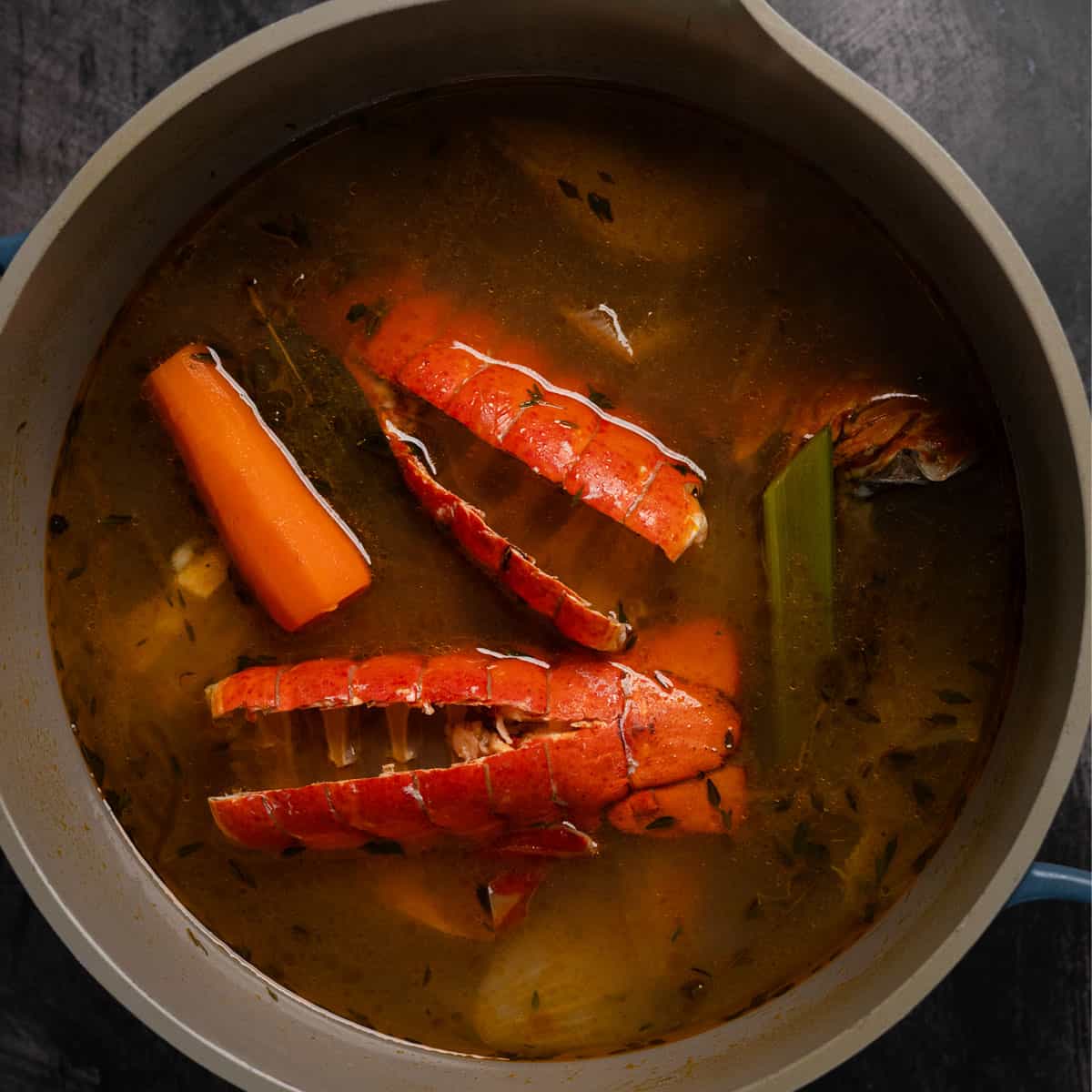 a stock pot filled with lobster stock and lobster stock ingredients