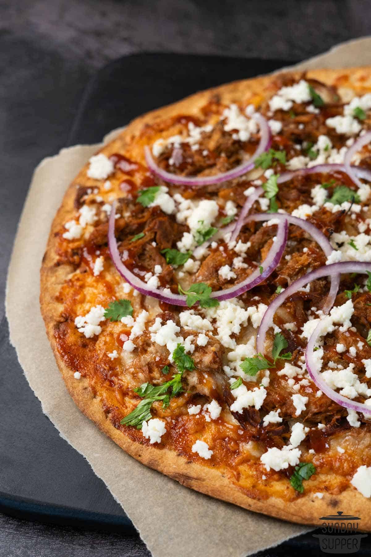 a close up of a whole pulled pork pizza