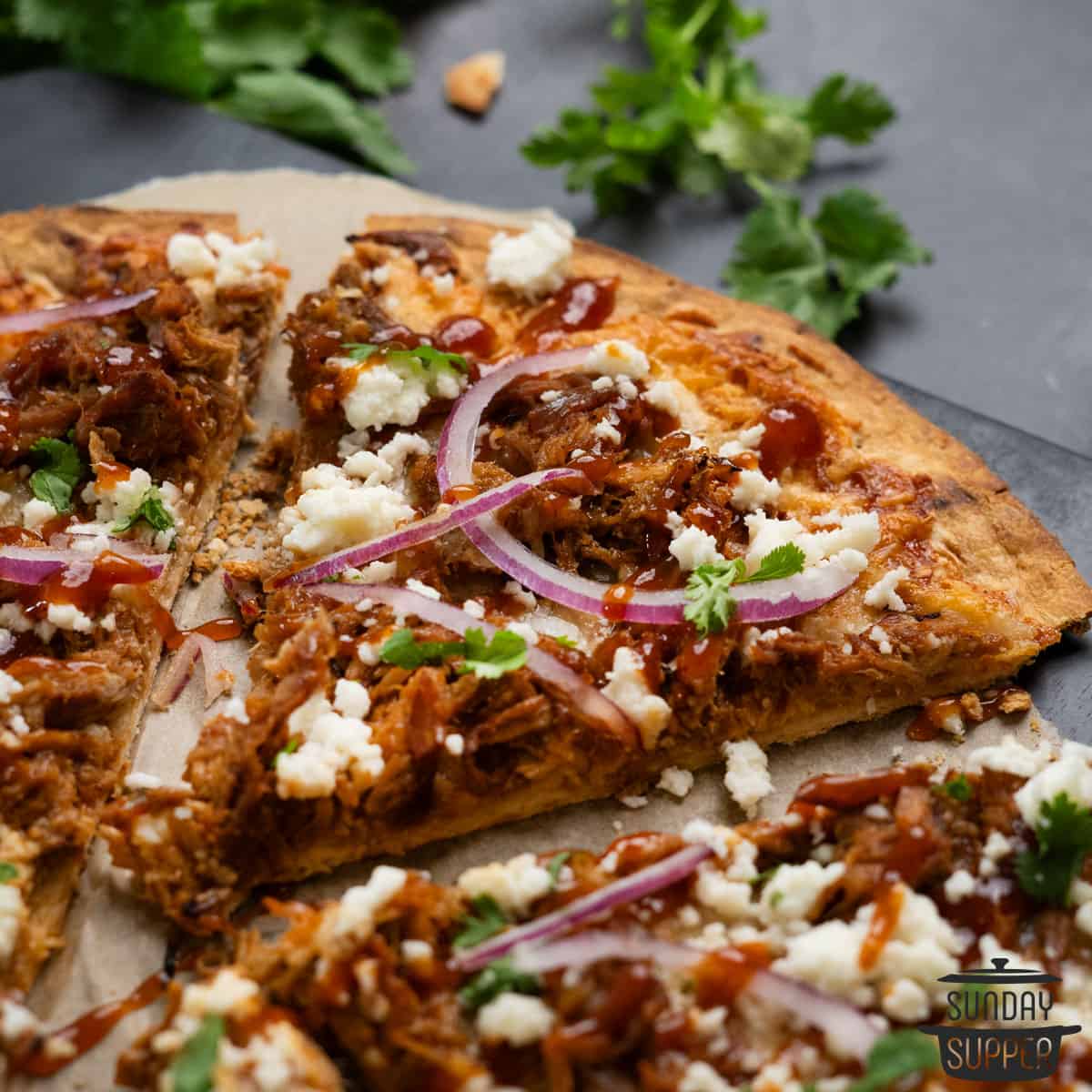 close up of a slice of pulled pork pizza