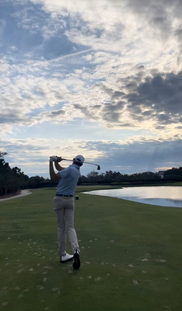 riley golfing under a beautiful sky