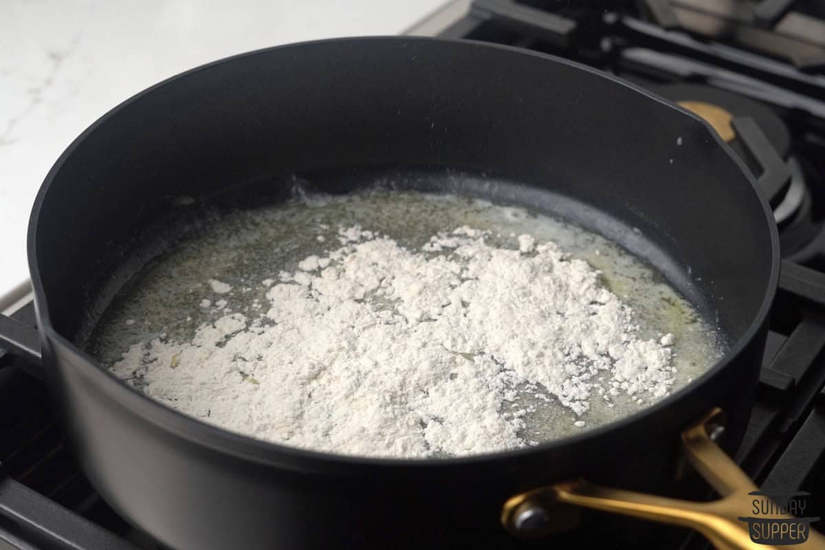 adding flour to butter in a skillet