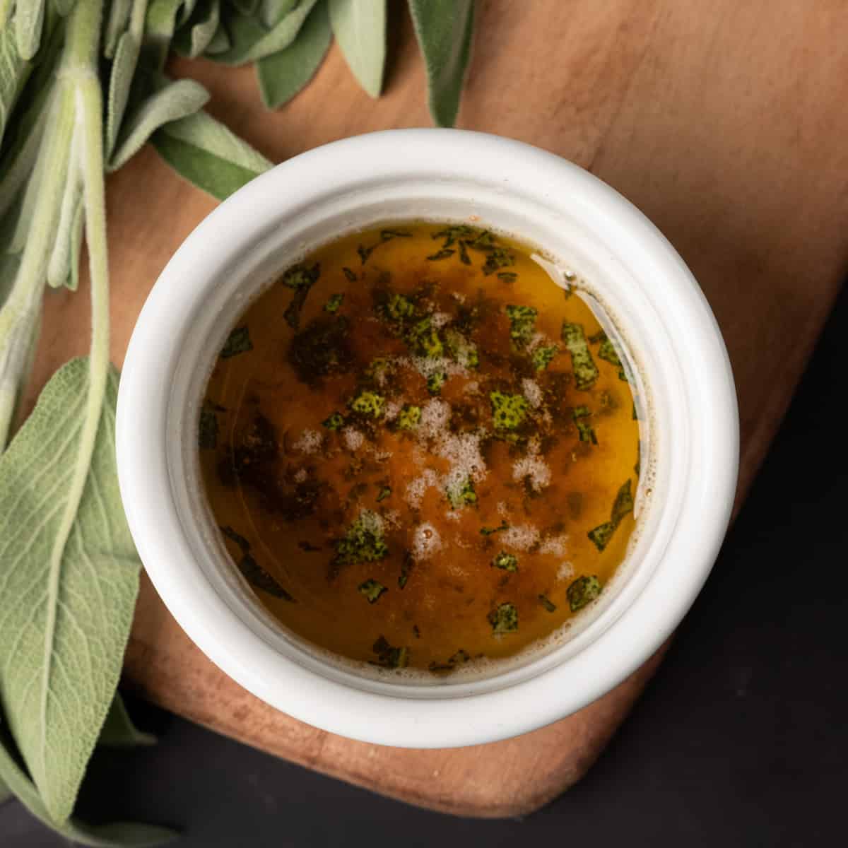 sage butter sauce in a white bowl