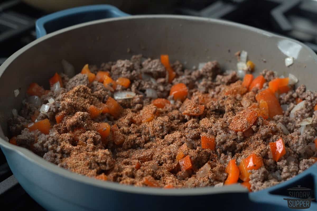 seasoning taco meat in a pan