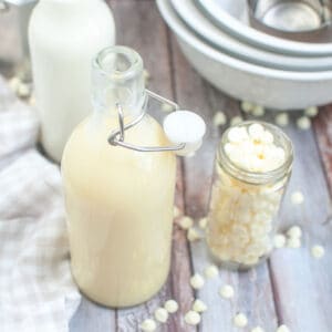 a bottle of white chocolate sauce with an extra bottle of white chocolate chips