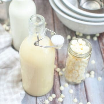 a bottle of white chocolate sauce with an extra bottle of white chocolate chips